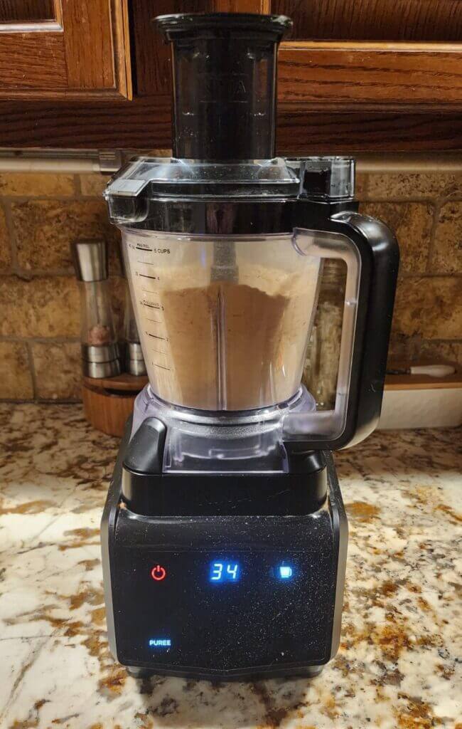 Ninja food processor grinding dried hot peppers into powder.